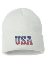White USA cuffed beanie featuring "USA" text with an American flag design, perfect for showing patriotic pride.
