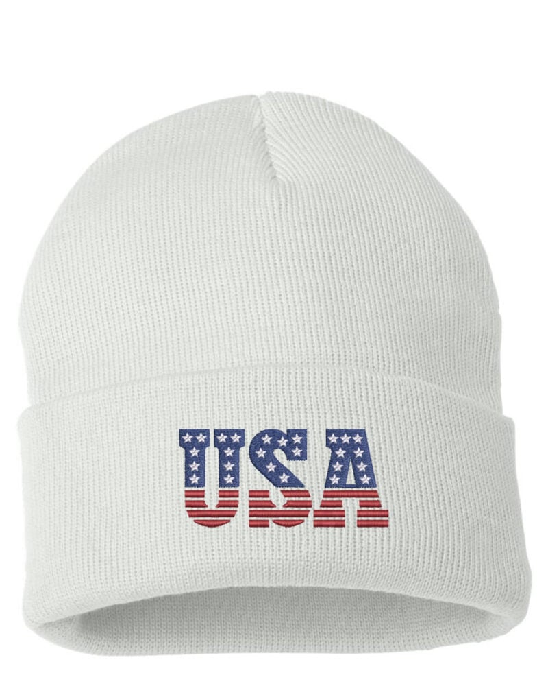 White USA cuffed beanie featuring "USA" text with an American flag design, perfect for showing patriotic pride.