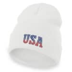 White cuffed beanie with embroidered USA flag design in red, white, and blue.