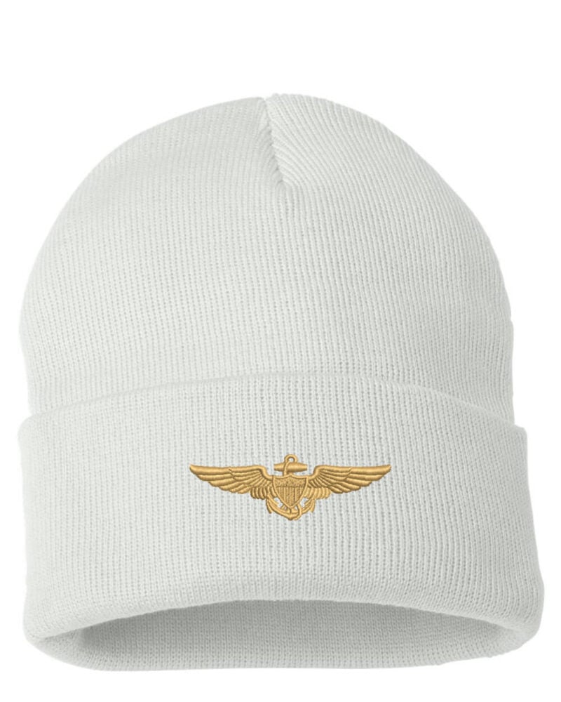 White cuffed beanie featuring a gold Navy Aviator Pilot Wings emblem on the front, displayed on a product page.