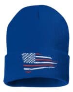 Blue cuffed beanie featuring a distressed American flag design, perfect as a patriotic gift or stylish accessory.