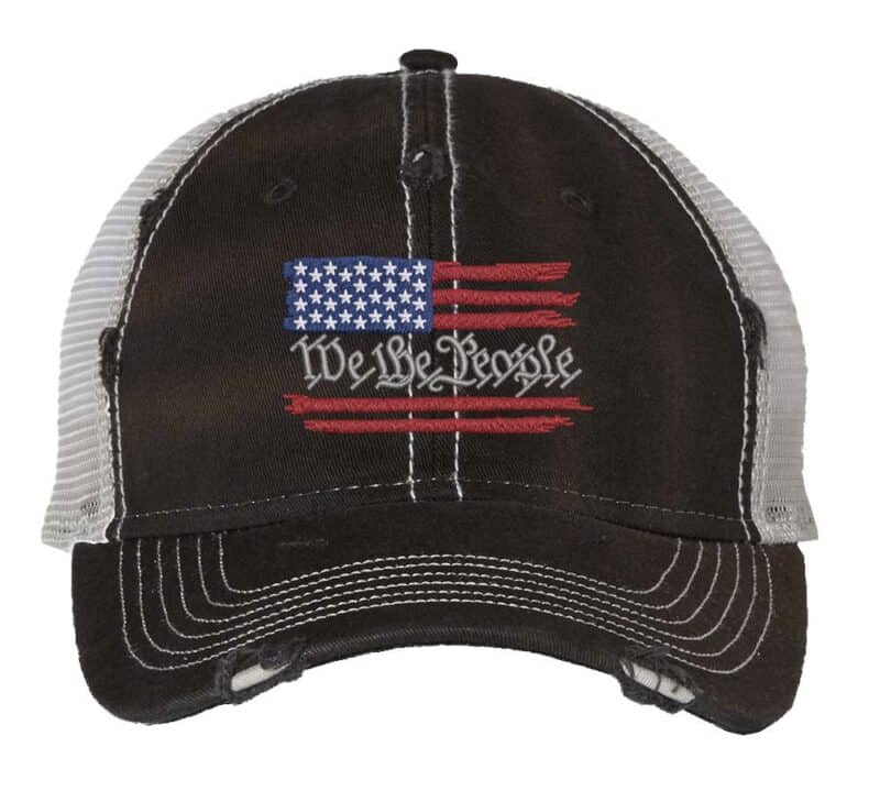 We The People trucker hat with distressed American flag embroidery featuring constitutional preamble text and breathable mesh back