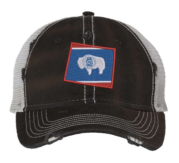 Distressed Wyoming trucker hat with embroidered state flag design, mesh back, and adjustable strapback closure.