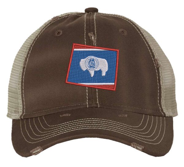 Distressed Wyoming trucker hat with embroidered state flag design, mesh back, and adjustable strapback closure.