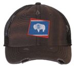 Distressed Wyoming trucker hat with embroidered state flag design, mesh back, and adjustable strapback closure.