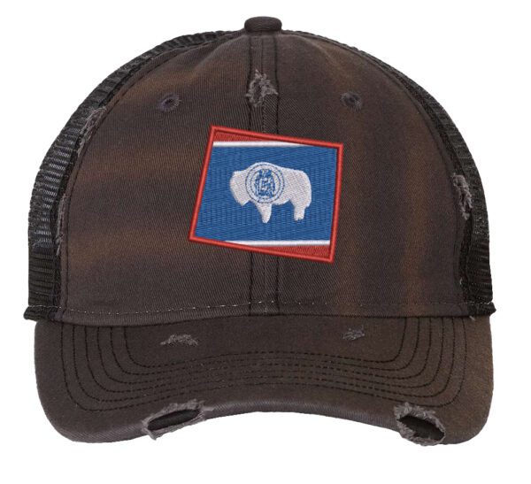 Distressed Wyoming trucker hat with embroidered state flag design, mesh back, and adjustable strapback closure.