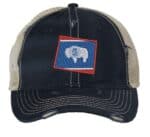 Distressed Wyoming trucker hat with embroidered state flag design, mesh back, and adjustable strapback closure.