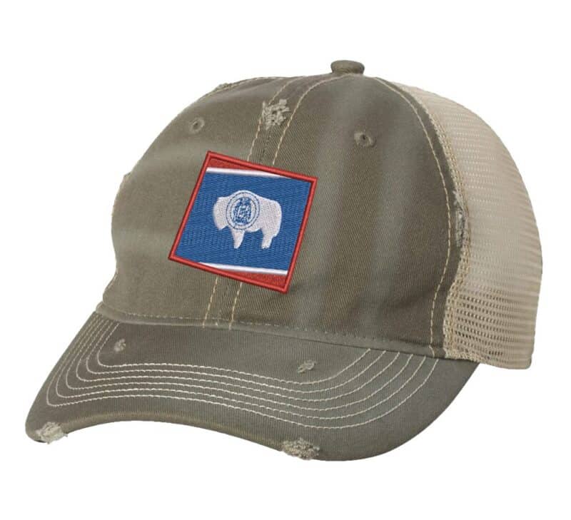 Distressed Wyoming trucker hat with embroidered state flag design, mesh back, and adjustable strapback closure.