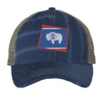 Distressed Wyoming trucker hat with embroidered state flag design, mesh back, and adjustable strapback closure.