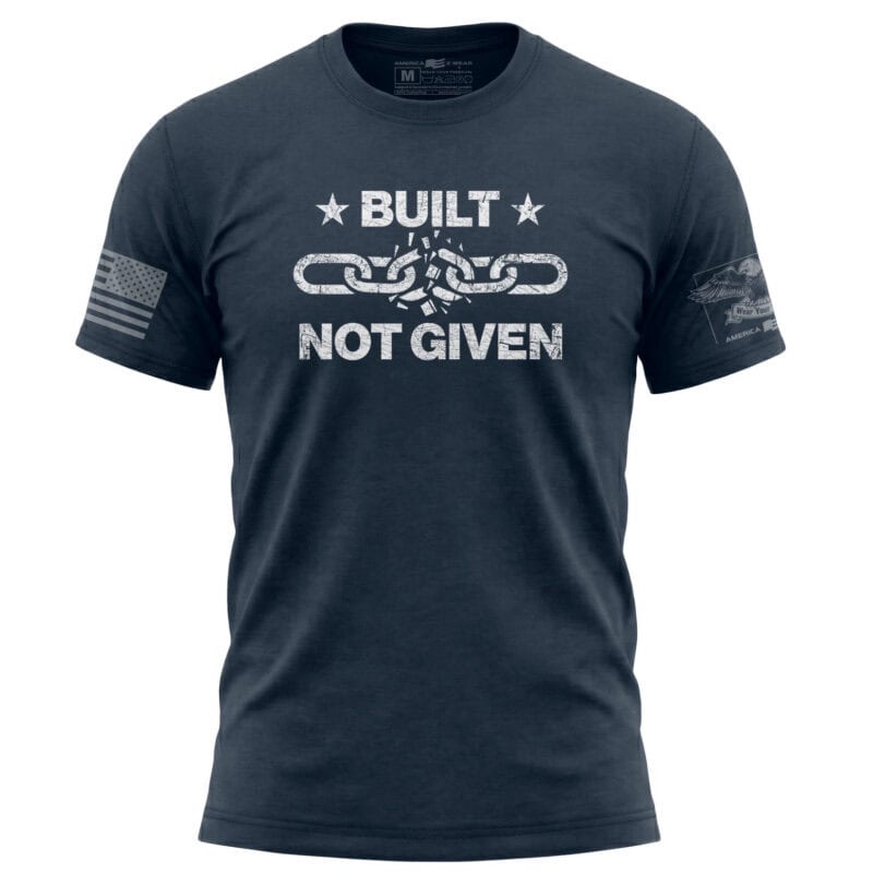 Patriotic navy T-shirt featuring a broken chain design with "Built Not Given" slogan, perfect for Am.