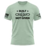 Patriotic mint T-shirt with "Built Not Given" slogan and broken chain graphic, perfect for American.