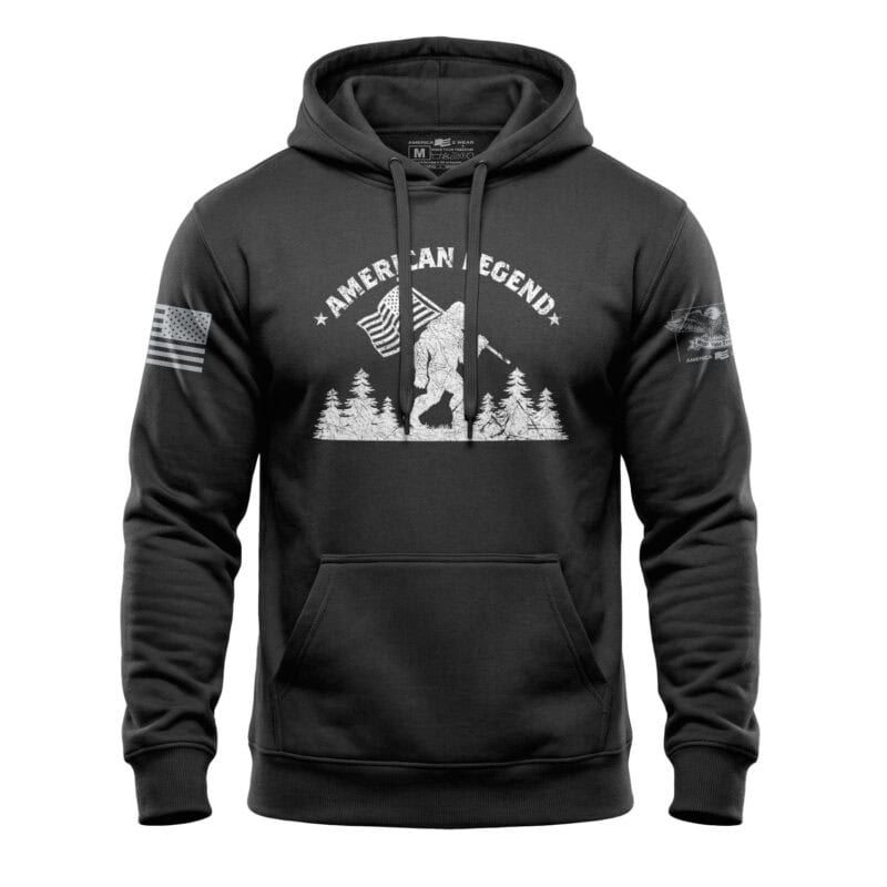 Patriotic Bigfoot hoodie with American flag and forest design, perfect for outdoor enthusiasts.