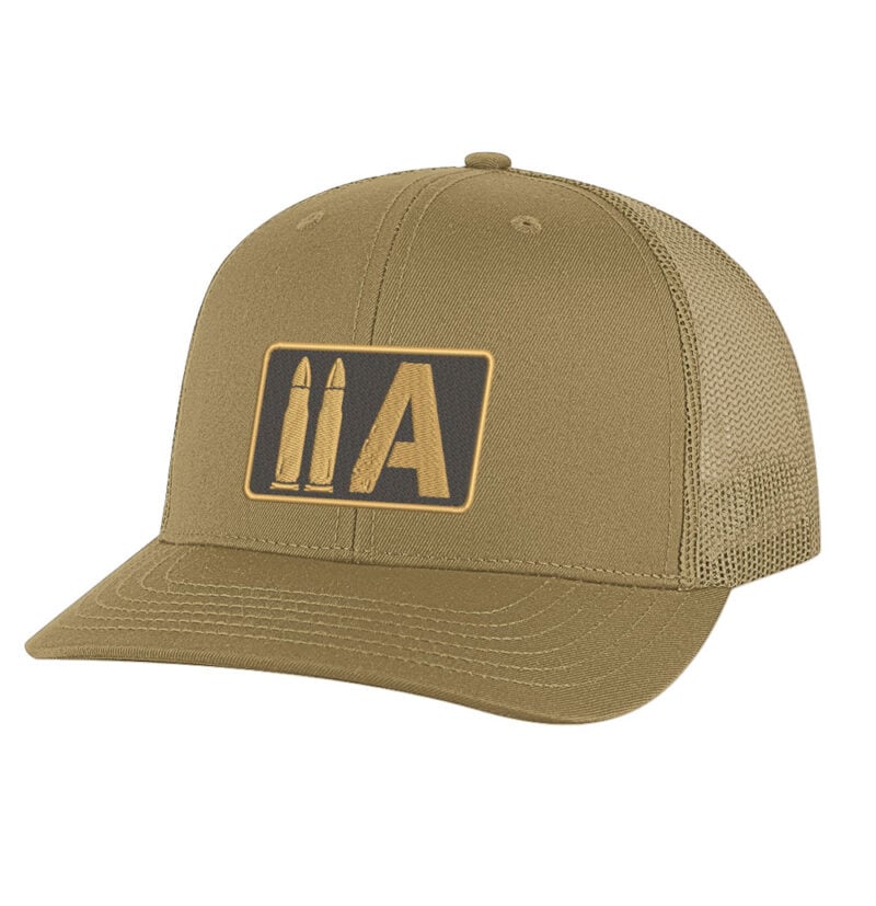 Military-style tan trucker cap with "IIA" logo and bullet graphic. 2nd Amendment trucker hat with gold embroidered two bullet 2A patch on black mesh snapback