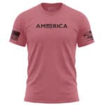 Pink American flag T-shirt with USA text and flag patch on sleeve.