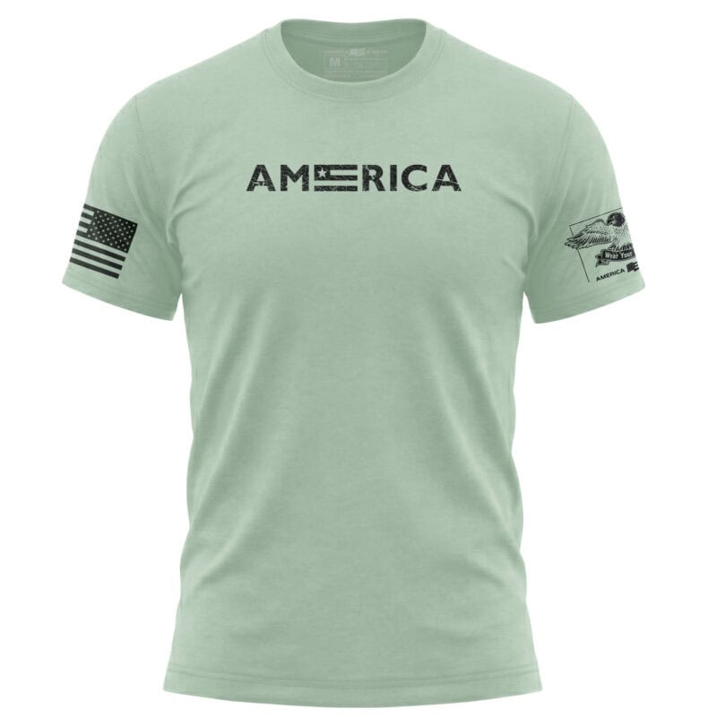Light green American flag T-shirt with USA flag patch on sleeve and "AMERICA" text on chest.