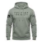 Comfortable green hoodie featuring "Everyday Patriot" text and American flag patch on sleeve.