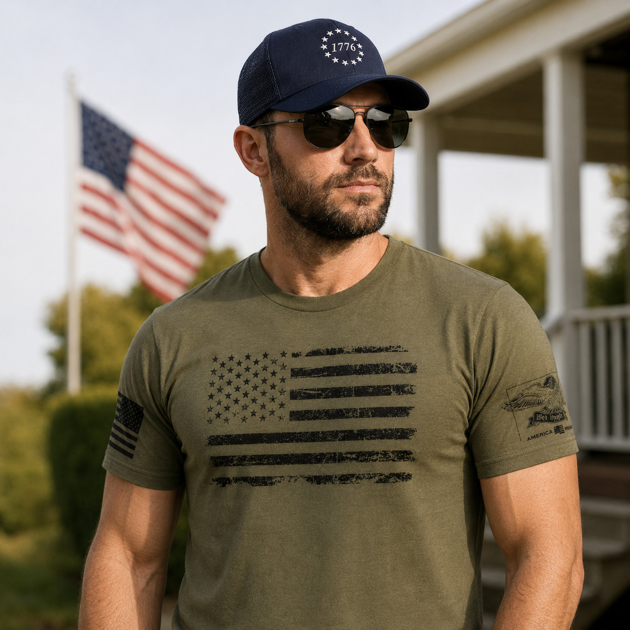 Man wearing a patriotic American flag T-shirt and embroidered 1776 trucker hat