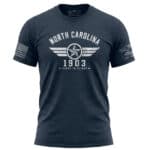 North Carolina First in Flight T-Shirt with aviation design and American flag detail.
