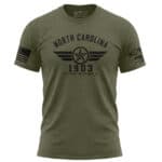 Olive green T-shirt with aviation history design and North Carolina 1903 text.