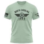 North Carolina First in Flight T-Shirt with aviation design and flags.