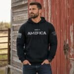Made in America hoodie with patriotic design on a man outdoors.